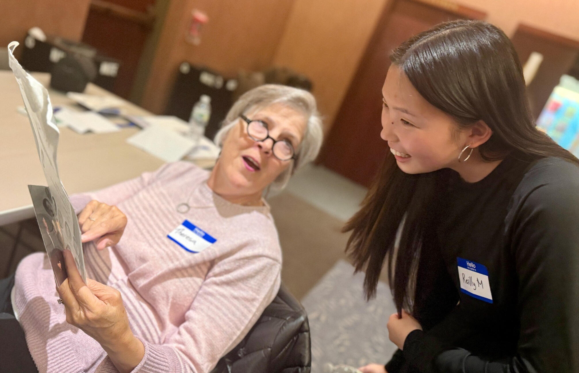 Reilly Maier of Timeless Treasures Nyack listens as a lifelong learner shares a family photograph.